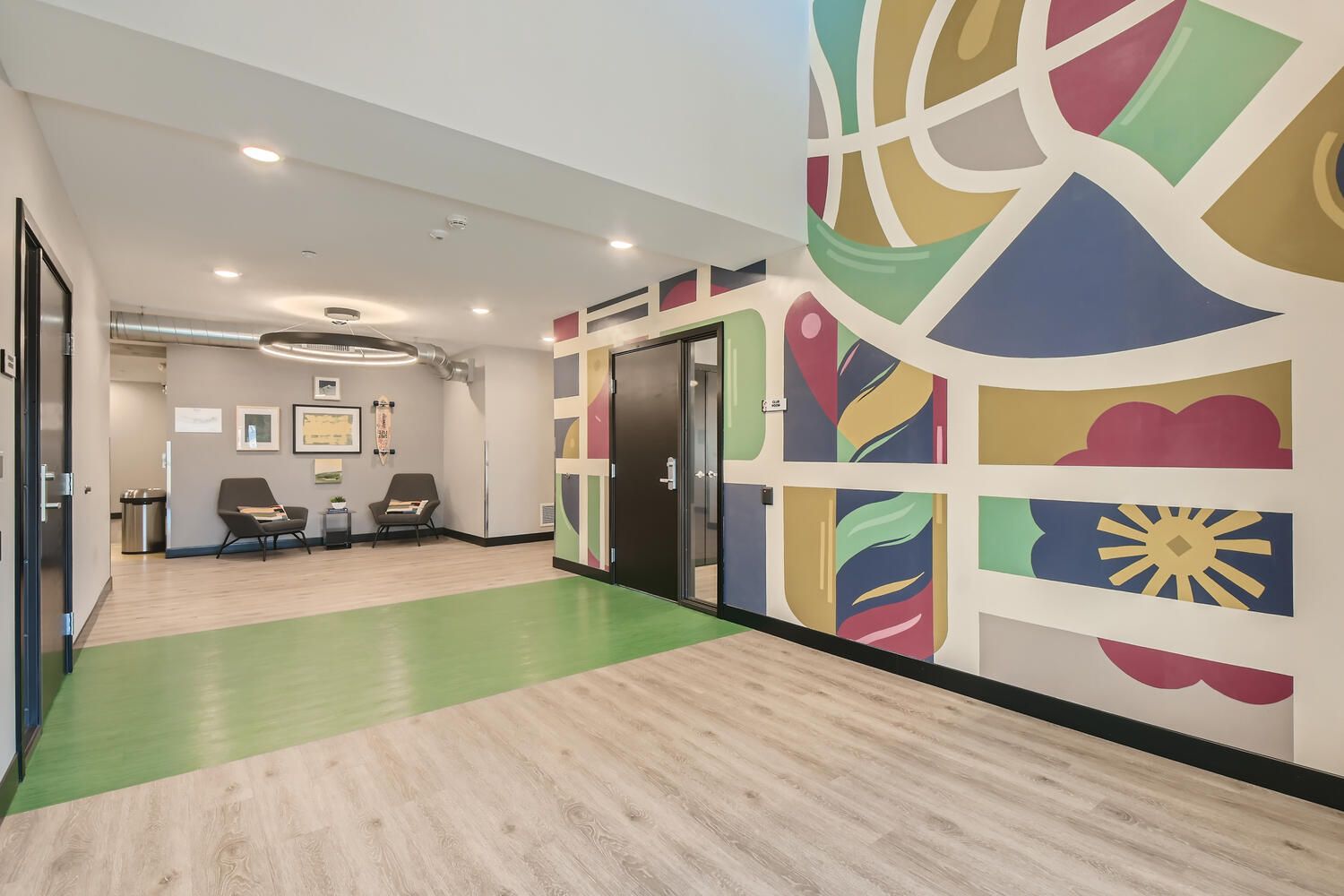 Lobby seating area with mural at Beam affordable apartments and townhomes