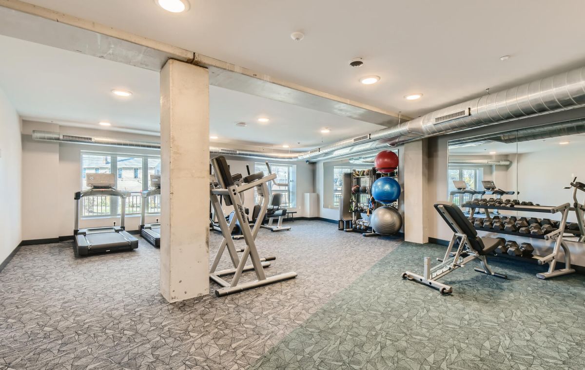 woman exercising in apartment fitness center